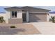 Charming single-story home featuring a neutral color palette, two-car garage and easy-to-maintain desert landscaping at 18224 W La Senda Dr, Surprise, AZ 85387