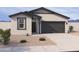 Charming single-story home with a neutral color palette, two-car garage, and desert landscaping at 18243 W La Senda Dr, Surprise, AZ 85387