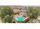 Beautiful home with a sparkling pool, patio area, and well-maintained yard at 18419 W Maui Ln, Surprise, AZ 85388