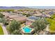 Home featuring a refreshing pool, a well-kept yard, and desert views at 18419 W Maui Ln, Surprise, AZ 85388