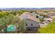 Home featuring a sparkling pool, mountain views, and solar panels at 18419 W Maui Ln, Surprise, AZ 85388