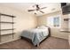 Cozy bedroom featuring a full-size bed with shelving and window providing natural light at 18419 W Maui Ln, Surprise, AZ 85388
