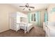 Bright bedroom with a loft bed, desk, shelving, and a ceiling fan at 18419 W Maui Ln, Surprise, AZ 85388