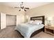 Bright primary bedroom with ceiling fan, plantation shutters, and a large walk-in closet at 18419 W Maui Ln, Surprise, AZ 85388