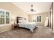 Primary bedroom featuring vaulted ceilings, plantation shutters, ceiling fan and luxury finishes at 18419 W Maui Ln, Surprise, AZ 85388