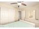 Cozy bedroom features include a ceiling fan, closet, and a dresser with mirror at 18419 W Maui Ln, Surprise, AZ 85388