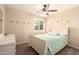 Light filled bedroom with a bed, dresser, and window with plantation shutters at 18419 W Maui Ln, Surprise, AZ 85388