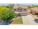 Beautiful two-story home with tile roof, three-car garage and well-manicured lawn at 18419 W Maui Ln, Surprise, AZ 85388