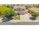 Beautiful home featuring a manicured lawn, garden, and three-car garage at 18419 W Maui Ln, Surprise, AZ 85388
