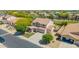 Attractive two-story home with a three-car garage, a well-kept lawn, and mature trees at 18419 W Maui Ln, Surprise, AZ 85388