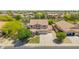 Lovely two-story home with a three-car garage, green lawn, and mature landscaping at 18419 W Maui Ln, Surprise, AZ 85388