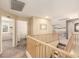 Upstairs hallway with staircase, view of the laundry room and open floorplan into living room at 18419 W Maui Ln, Surprise, AZ 85388