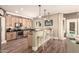 Well-lit kitchen with stainless steel appliances, breakfast bar, and access to outdoor pool at 18419 W Maui Ln, Surprise, AZ 85388
