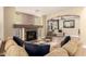 Comfortable living room with a brick fireplace, hardwood floors, and natural light, perfect for relaxing at 18419 W Maui Ln, Surprise, AZ 85388