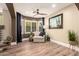 Bright and airy living room with large windows, modern furnishings, and hardwood floors at 18419 W Maui Ln, Surprise, AZ 85388