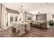 Open-concept living and dining area with hardwood floors and ample natural light at 18419 W Maui Ln, Surprise, AZ 85388