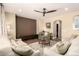 Comfortable living room featuring wood floors, ceiling fan, and ample seating space at 18419 W Maui Ln, Surprise, AZ 85388
