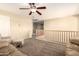 Open loft area with wood railing, ceiling fan, and cozy couches, perfect for relaxing at 18419 W Maui Ln, Surprise, AZ 85388