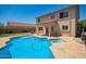 A spacious backyard with a private pool, spa, covered patio and lush greenery at 18419 W Maui Ln, Surprise, AZ 85388