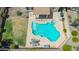 Aerial view of a backyard pool with a spa, covered patio, table, and chairs at 18419 W Maui Ln, Surprise, AZ 85388