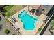 Aerial view of a backyard pool with a spa, patio, and table and chairs at 18419 W Maui Ln, Surprise, AZ 85388