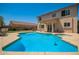 Relaxing pool and patio area features outdoor seating with a manicured lawn at 18419 W Maui Ln, Surprise, AZ 85388