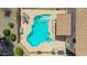 Aerial view of a backyard pool with a spa, patio, table, and chairs at 18419 W Maui Ln, Surprise, AZ 85388