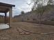 A backyard surrounded by a block wall and a hill in the background at 18447 W Verdin Rd, Goodyear, AZ 85338