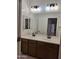 Bathroom with dual sink vanity, updated cabinets, and tile floors at 18447 W Verdin Rd, Goodyear, AZ 85338