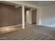 Open-concept living area with gray accent wall and tile/carpet flooring at 18447 W Verdin Rd, Goodyear, AZ 85338