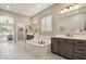 Spacious bathroom showcases a soaking tub, double vanities, and white tile flooring at 18530 E Mockingbird Ct, Queen Creek, AZ 85142