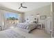 Bright bedroom with a large window, neutral tones, and a comfortable bed with stylish bedding at 18530 E Mockingbird Ct, Queen Creek, AZ 85142