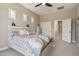 Comfortable bedroom featuring a ceiling fan, a large bed, and a closet with sliding doors at 18530 E Mockingbird Ct, Queen Creek, AZ 85142