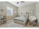 Inviting bedroom featuring a stylish bed frame, neutral walls, and a sunny window with shutters at 18530 E Mockingbird Ct, Queen Creek, AZ 85142