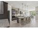 Well-lit kitchen featuring granite countertops, stainless steel appliances, and wood-look tile flooring at 18530 E Mockingbird Ct, Queen Creek, AZ 85142