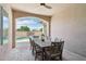 Covered patio features a dining table, ceiling fan, and a view of the inviting swimming pool at 18530 E Mockingbird Ct, Queen Creek, AZ 85142