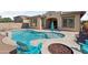 A lovely pool and patio includes an outdoor fire pit for relaxing evenings in the backyard at 18530 E Mockingbird Ct, Queen Creek, AZ 85142
