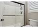 Modern bathroom features a glass enclosed walk-in shower with white tile and black trim at 18530 E Mockingbird Ct, Queen Creek, AZ 85142