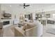 Open-concept living room with fireplace and seamless flow into the modern kitchen at 18530 E Mockingbird Ct, Queen Creek, AZ 85142