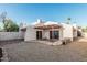 Backyard with decorative rock and stone landscaping, covered patio, and perimeter fencing at 1918 S Shannon Dr, Tempe, AZ 85281