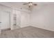 Neutral bedroom showing carpeted floor, ceiling fan, and doorway to adjoining room at 1918 S Shannon Dr, Tempe, AZ 85281