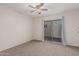Bedroom with neutral carpet and a sliding glass door leading to a private outdoor area at 1918 S Shannon Dr, Tempe, AZ 85281