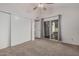 Bedroom with neutral walls, access to outdoor patio, carpeted floors, and closet with sliding doors at 1918 S Shannon Dr, Tempe, AZ 85281