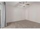 This bedroom features a ceiling fan, neutral walls, and wall-to-wall carpeting at 1918 S Shannon Dr, Tempe, AZ 85281