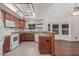 Traditional style kitchen with wood cabinetry, granite counters, and bright light fixtures at 1918 S Shannon Dr, Tempe, AZ 85281