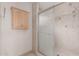 A bathroom shower featuring a sliding glass door and light-colored tile surround at 1918 S Shannon Dr, Tempe, AZ 85281