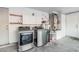 Bright utility room with modern washer and dryer, and storage cabinets at 1918 S Shannon Dr, Tempe, AZ 85281