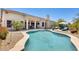 Refreshing backyard pool with desert landscaping, patio seating, and a built-in grill at 20608 N 57Th Ave, Glendale, AZ 85308
