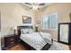 Bedroom with dark furniture, a ceiling fan, plantation shutters, and a full-length mirror at 20608 N 57Th Ave, Glendale, AZ 85308