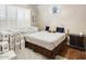 Cozy bedroom featuring plantation shutters and an area rug over hardwood floors at 20608 N 57Th Ave, Glendale, AZ 85308